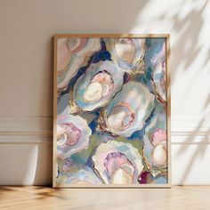 an abstract painting with seashells in pastel colors on a wall next to a potted plant