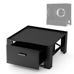 a black coffee table with two drawers and a speaker on it's side next to an empty box