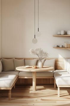 a living room filled with furniture and wooden flooring next to a wall mounted shelf