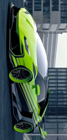 a green and black car hanging from the side of a building