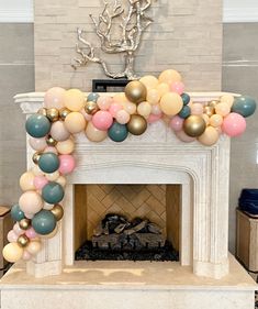 a fireplace decorated with balloons and confetti for a baby's first birthday