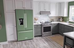 a kitchen with green and gray appliances in it