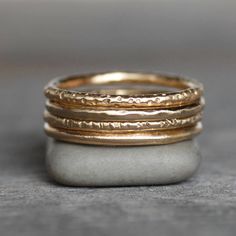 "This listing is for ONE solid 14k Gold band with your choice of textures. Classic gold band with a variety of textures to choose from. Wear it alone as a classic wedding band, or stack them up for a luxurious look! Sturdy enough for everyday wear. Details - Band - 1.6mm with your choice of textures Gold - eco-friendly, recycled Ring Size - Please leave your ring size in the \"message to seller\" section at checkout **Also available in 2mm wide. Please ask for pricing. **Also available in 14k ro Pebble Ring, Elegant Wedding Rings, Gold Stacking Ring, Gold Items, 14k Gold Wedding Band, Minimalist Accessories, Wax Carving, Diamond Stacking Rings, Classic Wedding Band