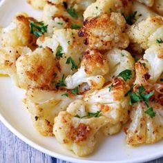 cauliflower on a white plate topped with parsley