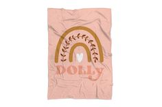 a pink towel with an image of a rainbow and the word doly on it