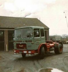 an old truck parked in front of a building