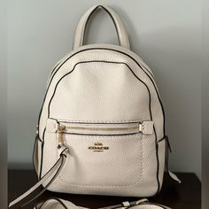 Coach Backpack, Never Used, New With Tags! Cream Color, Comes With Removable Strap Leather Backpack With Zipper Closure In Cream, White Backpack With Removable Pouch For On-the-go, Cream Leather Backpack With Zipper Closure, Cream Leather Backpack With Adjustable Strap, Luxury Leather Backpack In Cream, Cream Leather Backpack For Daily Use, White Leather Backpack With Detachable Strap For Everyday, Luxury Cream Leather Backpack, White Coach Backpack For Everyday Use