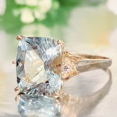 5.00 Carat Natural Aquamarine & Diamonds 14k Solid Gold Ring Ring Material: 14k Solid Gold Total Metal Weight: 3.8 Grams Gemstone: Natural Aquamarine Gemstone Color: Pale Blue (Aqua) Gemstone Shape: Cushion Gemstone Dimensions: 12.00x10.00 mm Gemstone Quantity: 1 Gemstone Carat Weight: 4.90 Carat Diamonds: Natural Round Shaped Diamonds Quantity: 2 Diamonds Total Carat Weight: 0.10 Carat Total Carat Weight: 5.00 Carat Ring Face Measures: 12.00x13.60 mm Ring Quantity: One Ring Condition: New Made Luxury 14k Gold Topaz Ring With Vs Clarity, 14k Gold Cushion Cut Sapphire Ring For Anniversary, Gia Certified Yellow Gold Topaz Wedding Ring, Gia Certified Yellow Gold Topaz Ring, Gia Certified Gold Topaz Ring, Fine Jewelry 14k Gold Gia Certified Sapphire Ring, 14k Rose Gold Sapphire Ring For Formal Occasions, Gia Certified Yellow Gold Topaz Ring As Gift, Gia Certified 14k Gold Sapphire Ring