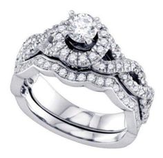 a wedding ring set with two matching bands and a center diamond on the band, in white gold