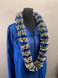 a woman's blue graduation gown with ruffles on the neck and sleeves