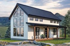 a white house with a black metal roof and windows on the front porch, overlooking mountains