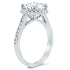 a white gold engagement ring with an oval cut center stone and pave set shoulders