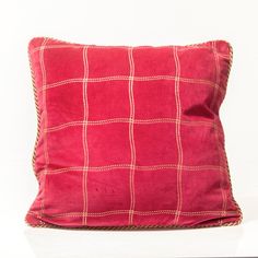 a red pillow with white squares on it