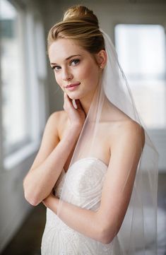 Breathtaking in its ethereal simplicity, this veil is handmade from fine tulle in a graceful U-shape and gathered at the hair comb. 106" length Silvertone-plate hair comb 100% nylon Spot clean Made in the USA of imported materials Plain Veil, Bridal Portraits Outdoor, Elegant Veils, Bridal Dresses Vintage, Bride Hair Pins, Bridal Hair Veil, Bridal Bun, Cathedral Length Veil, Veil Styles