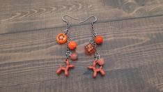 These cute mismatched balloon animal earrings feature several different beads and charms attached to one chain to make whimsical dangle earrings. From top to bottom one earring features a an orange smiley face, two spherical beads in different sizes, and a balloon animal charm at the bottom. The other earring features an orange spherical bead, a orange six sided dice charm, a smaller orange spherical bead, and the balloon animal at the bottom. These lightweight and nickle free earrings are the perfect clowncore gift for a tween or teen girl! Each earring is approximately 2.25" long and 0.5" wide on surgical steel ear hooks Ships in 1-5 business days Spend over $35 pre-tax to get free shipping anywhere in the US! Please contact us if you are interested in gift wrapping or a custom order. Re Stocking Stuffers For Teenage Girls, Ballon Animal, Smiley Face Earrings, Face Earrings, Animal Earrings, Balloon Animals, Free Earrings, Ear Hook