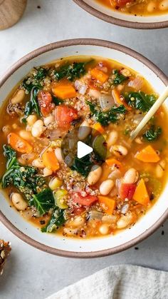 two bowls filled with soup and vegetables on top of a table