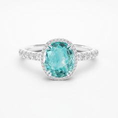 ITEM INFORMATION Gemstone:  * Paraiba Tourmaline & Diamond Paraiba Tourmaline:  * Weight: 1.50 carats * Cut: Oval Diamonds:  * Grade: G / VS-VVS Metal: * 18K White Gold * Platinum 950 Ring Dimensions: * 9x7mm (Including diamond halo) Also available in: * Different Dimensions & Gemstones * 18K Yellow Gold & 18K Rose Gold Certification: * Complimentary certificate of authenticity * Complimentary GIA or GRS certification (All our gemstones and metals are responsibly mined and traceable to their sou Paraiba Ring, Eternity Ring Gold, Paraiba Tourmaline, Tourmaline Stone, 18k Gold Ring, Gifts For My Wife, Platinum Ring, Diamond Halo, Oval Diamond