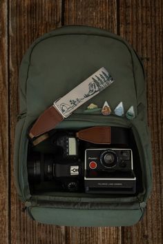 a camera and some other items in a backpack