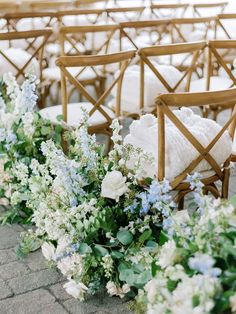 rows of chairs with white and blue flowers on them