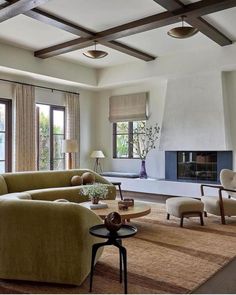 a living room filled with furniture and a fire place in the middle of a room