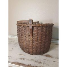 a brown basket sitting on top of a white table