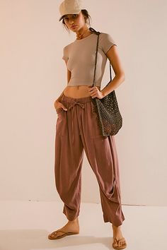 Breezy and effortless, these timeless pants from free-est are a true seasonless staple. **Fit:** Mid-rise, relaxed harem fit **Features:** Pull-on design, drawstring closure, dropped pouch pockets, tucked pleating seam **Why We ❤ It:** Off-duty with your favorite tee or perfectly paired with the matching skirt, this pair has endless ways to wear. | Take Me With You Linen Pants by free-est at Free People in Brown, Size: XS Massage Therapist Outfits For Women, Brown Relaxed Fit Harem Pants With Tapered Leg, Brown Tapered Leg Harem Pants With Relaxed Fit, Versatile Tapered Leg Harem Pants For Loungewear, Natural Fibers Clothing, Linen Pants Outfit, Linen Drawstring Pants, Dream Outfits, Boho Pants