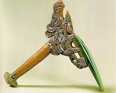 an intricately designed wooden object with green glass in the top and bottom part, on a white background