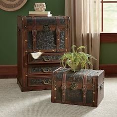 two pieces of luggage sitting on the floor in front of a green wall and window