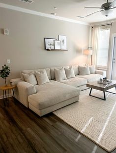 a living room filled with furniture and a large white couch in front of a sliding glass door