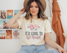 a woman sitting on the floor wearing a hat and t - shirt that says grooy mama