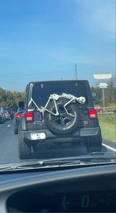 there is a bike that is on the back of a truck's tailgate