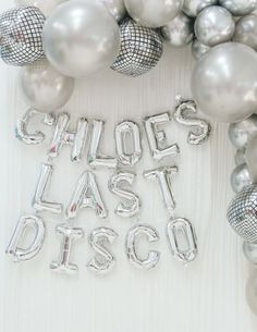 some silver balloons are laying next to each other and the words choices last disco spelled out