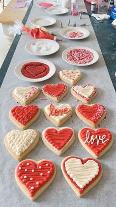 heart shaped cookies are on the table ready to be decorated