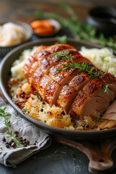 Roast pork loin with crispy skin, garnished with herbs, served with mashed potatoes and sautéed cabbage. Pork Aesthetic, Pork Loin With Sauerkraut, Tender Pork Loin, Oven Roasted Pork Loin, Pork And Sauerkraut Recipe, Pork And Sauerkraut, Oven Roasted Pork, Roasted Pork Loin