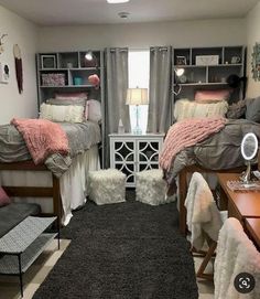 a dorm room with two beds and a desk