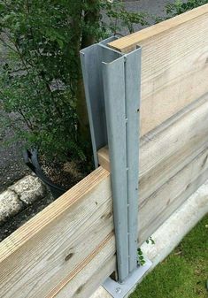 a person standing next to a wooden fence