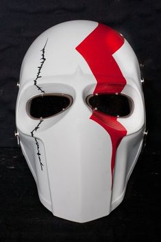 a white mask with red paint on it