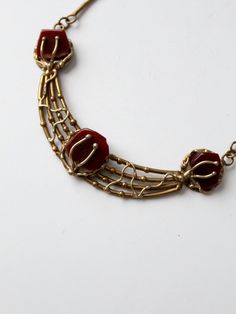 A vintage brutalist style brass necklace with stone insets. Stunning brass work shapes the center of the necklace with inset reddish-brown stones. Rings and brass bars shape the back of the necklace with a simple hook closure.CONDITIONIn good condition with wear consistent with age and use.MEASUREMENTSLength: 15. 75" - 18" 40 cm - 45. 7 cmCenter piece: 5. 75" x 1" 14. 6 cm x 2. 5 cm111592 Brutalist Jewelry, Stones Rings, Necklace With Stone, Brutalist Design, Red Stones, Bib Necklaces, Vintage Clothing Online, Brass Necklace, Reddish Brown