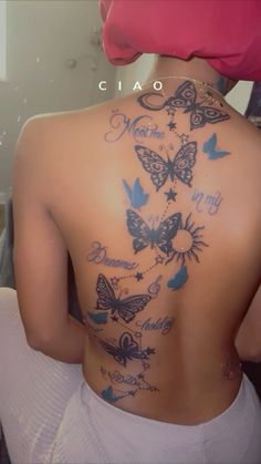 the back of a woman's body with butterflies on it