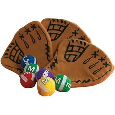 three mitts and four balls are shown in this image, one has the word m & m on it