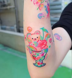 a person with colorful tattoos on their arm