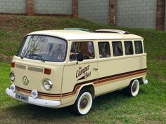 an old vw bus is parked in the grass