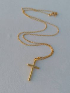 A nice, dainty 14k gold filled necklace with an eye catching plain cross. A dainty Christian necklace that protects the person wearing it. A nice gift for her Length approx. 15 inches / 38 cm - with 1.2 inch extension. ♥ All items will come in a nice gift box ♥ ★ Read our policies before purchase: https://www.etsy.com/shop/Jewellusion/policy/ ★ Convo me for custom orders or any questions you might have ♥ Visit our shop for more fabulous jewels: https://www.etsy.com/shop/Jewellusion/ μ ♥ Follow m Simple Yellow Gold Cross Necklace, 14k Gold Filled Cross Pendant Necklace As Gift, 14k Gold Filled Cross Necklace Gift, Simple Gold Cross Pendant Necklace, 14k Gold Filled Cross Charm Necklace For Gift, 14k Gold Filled Cross Charm Necklace As Gift, Gold Cross Necklace For Everyday, Simple Gold Cross Necklace As A Gift, Everyday Gold Cross Necklace