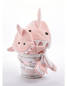 a pink baby shark hat and booties in a bucket