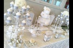 a table topped with lots of cakes and cupcakes