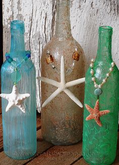 three vases with starfish on them sitting next to each other