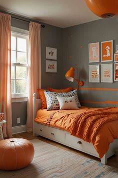 a bedroom decorated in orange and gray with pictures on the wall