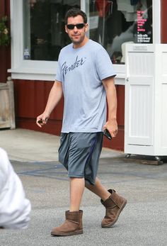 a man walking down the street wearing boots