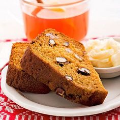 two slices of banana bread on a plate next to a bowl of ice cream and a cup of tea