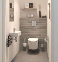 a white toilet sitting inside of a bathroom next to a wall mounted sink and mirror